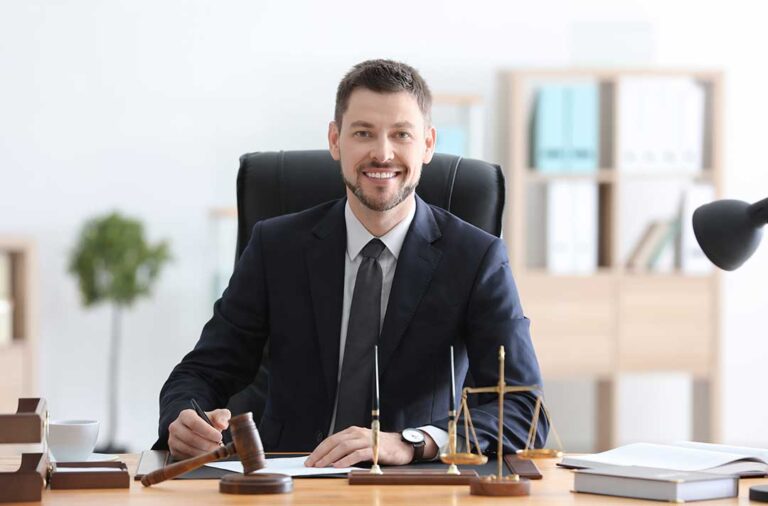 A couple reviews divorce forms and financial documents at a dining table with folders and a calculator.